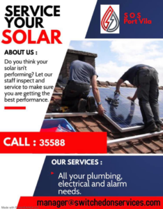 Two electricians from S O S Port Vila servicing solar panels on a rooftop in Port-Vila, Vanuatu.