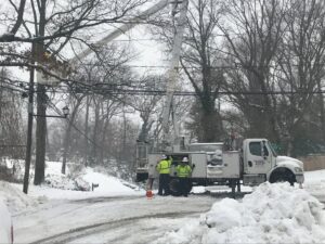 BESCO electricians with a utility truck on a snowy road, performing electrical work in Knoxville, TN.