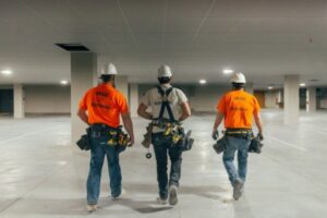 Three electricians from Brase Electrical Contracting Corp walking on a commercial job site in Omaha, NE.