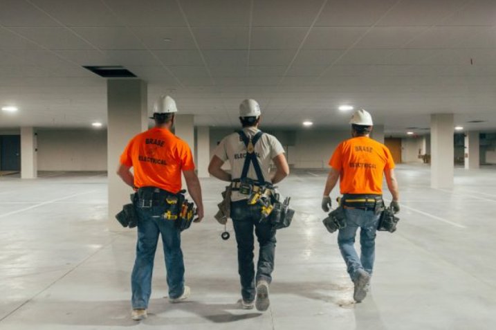 Three electricians from Brase Electrical Contracting Corp walking on a commercial job site in Omaha, NE.