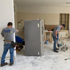 Electricians from Fuller Electrical Contractors, Inc. working on a construction site in Oldsmar, FL, installing new wiring.