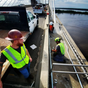 Electricians working on bridge wiring and conduit installation for Dobson Electric, Inc. in Jacksonville, FL.