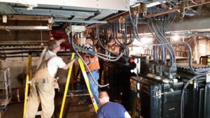 Electricians from Titan Electric working on large electrical panels and transformers in Bellevue, WA.