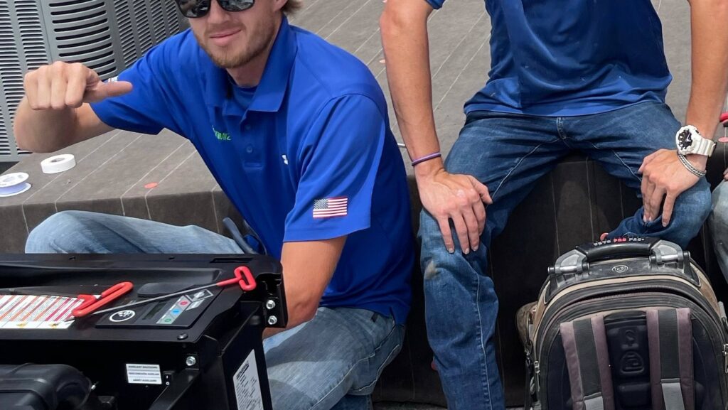 Two electricians from Optimize Generator People working on a generator in Baton Rouge, LA.