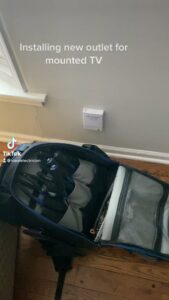 Electricians from Neighborhood Electric using a bucket truck to work on power lines in West Chicago, IL, with service vans parked nearby.