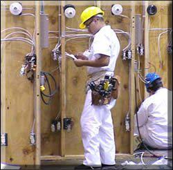 Two electricians working on electrical wiring installation for Frank's Electric, LLC in Albuquerque, NM.