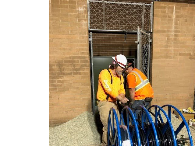 Electricians from High Tech Electric inc. working with electrical cables and spools at a commercial site in Van Nuys, CA.
