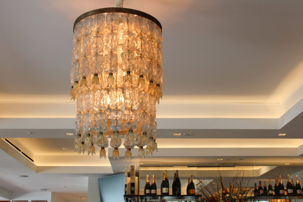 An elegant, multi-tiered chandelier installed in a commercial space by ACJ Electric LLC in North Babylon, NY.