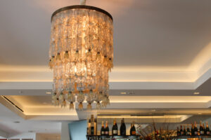 An elegant, multi-tiered chandelier installed in a commercial space by ACJ Electric LLC in North Babylon, NY.