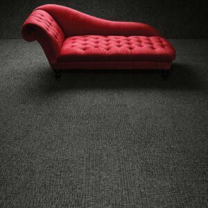 An elegant room with a red chaise lounge and dark grey patterned carpet, a professional installation by Eastpointe Interiors in Caledonia, MI.