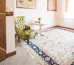 An elegant room featuring a large, light-colored oriental rug from J and J Oriental Rug Gallery in Alexandria, VA.