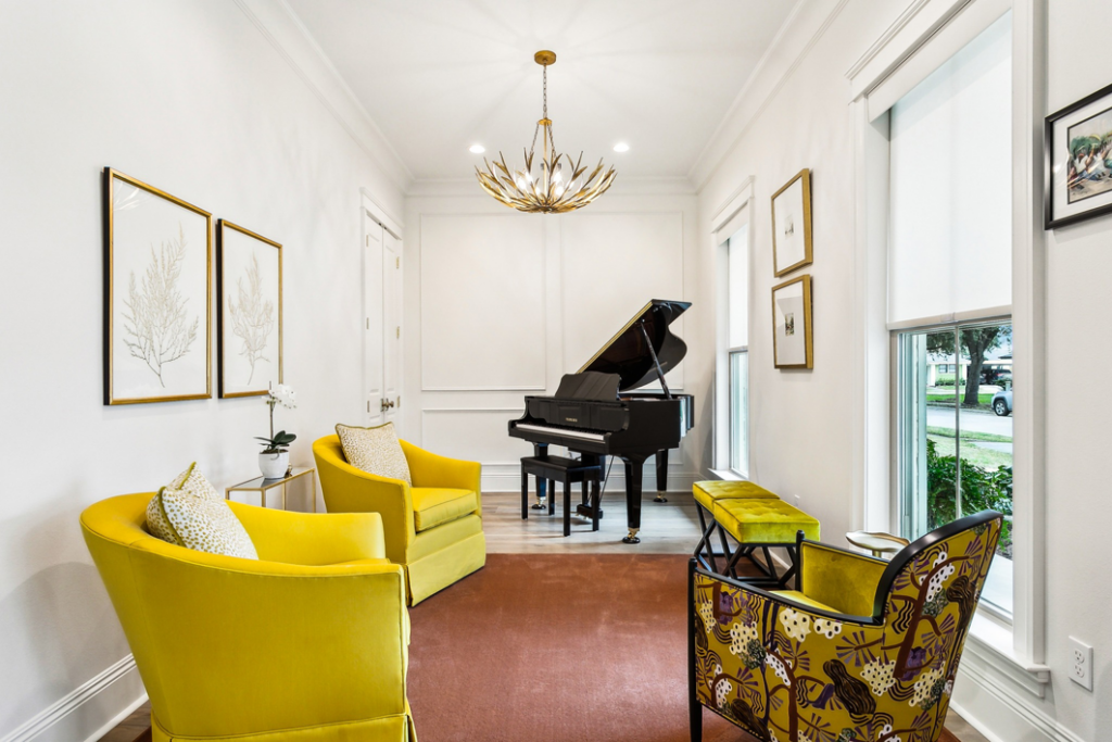 An elegant room with a grand piano and a solid color carpet installed by Adda Carpet and Flooring in New Orleans, LA.
