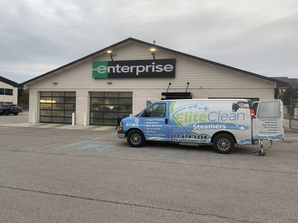 Elite Clean Steamers branded van with carpet cleaning equipment parked at a commercial job site in Indianapolis, IN
