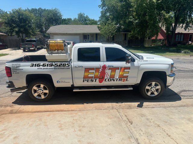 An Elite Pest Control service truck parked in front of a residential home in Maple Grove, MN.