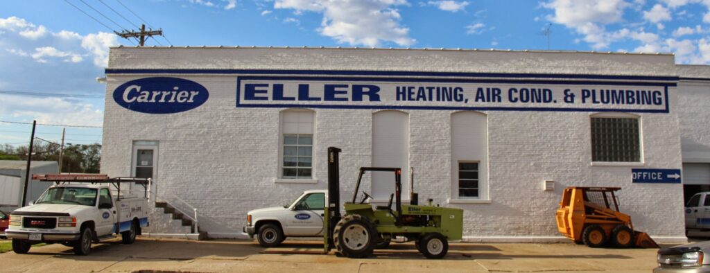 The exterior of Eller Heating & Air Conditioning LLC building with service vehicles parked outside in Columbus, NE.