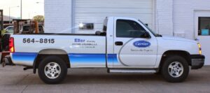 A white Eller Heating & Air Conditioning LLC service truck with Carrier branding in Columbus, NE.