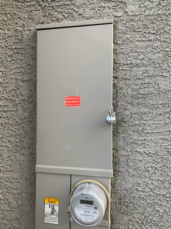 An exterior emergency disconnect electrical panel with a padlock, installed by Canyon Electric Company, Inc. in North Las Vegas, NV