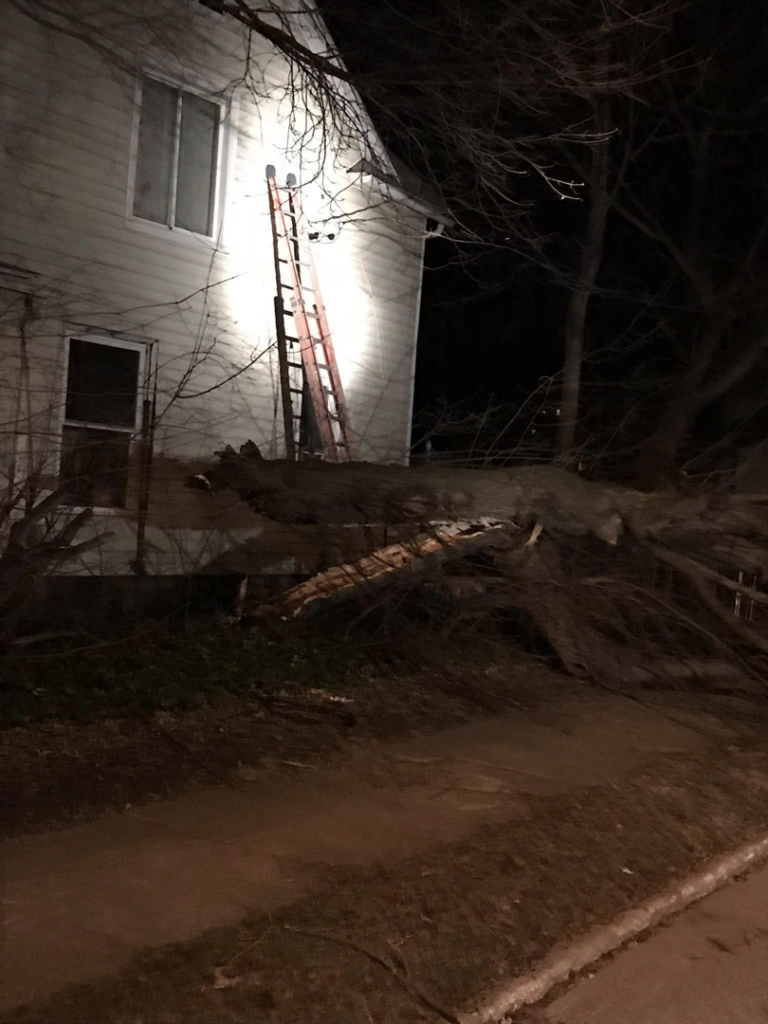 A ladder leaning against a house for emergency electrical repair after a fallen tree caused storm damage by DRS Electric Co. in Erie, PA.