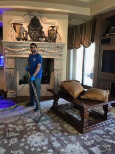 An Arizona Steamers Carpet Care employee cleaning a large area rug in a home in Phoenix, AZ.
