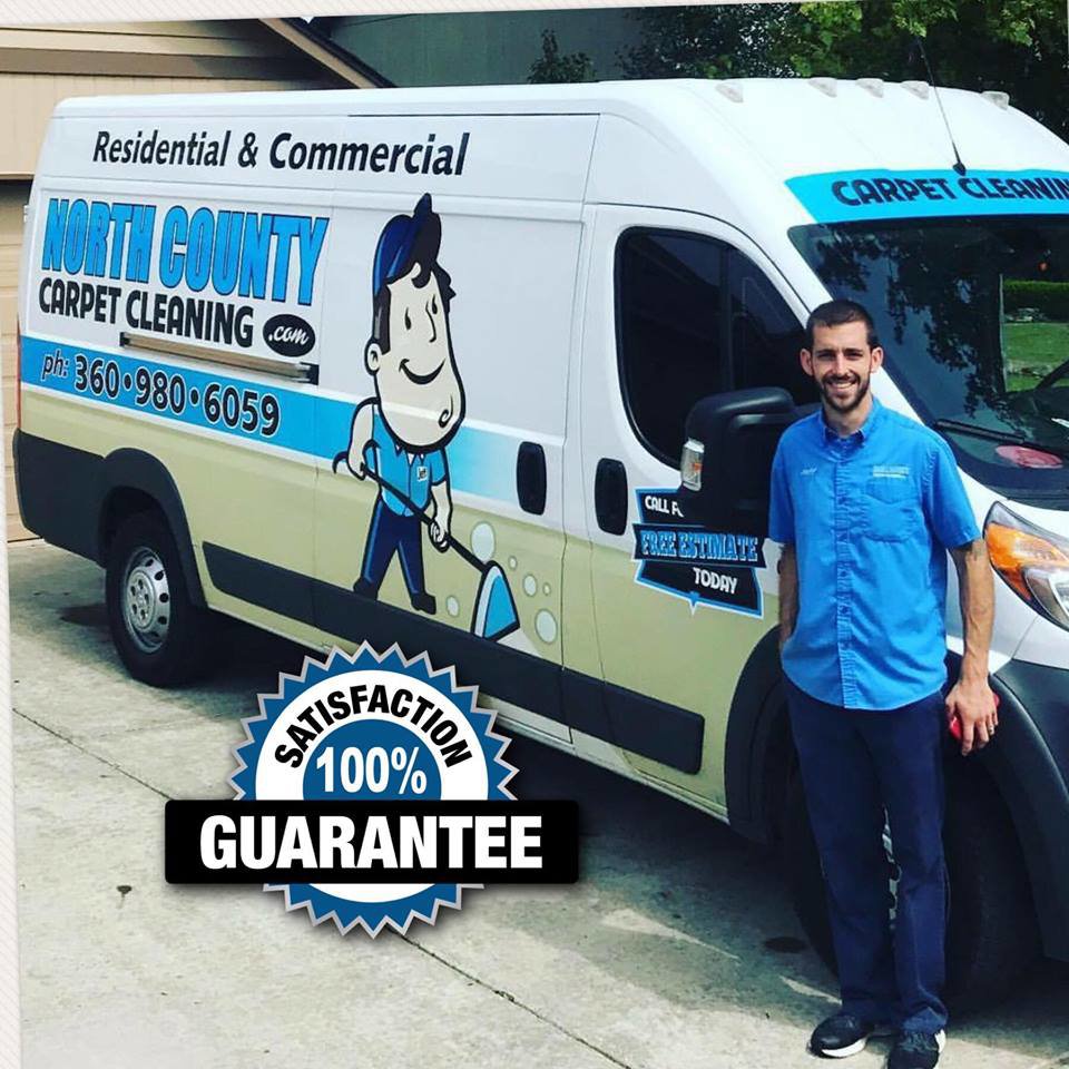 An employee standing proudly next to a branded carpet cleaning van for North County Carpet Cleaning in Vancouver, WA