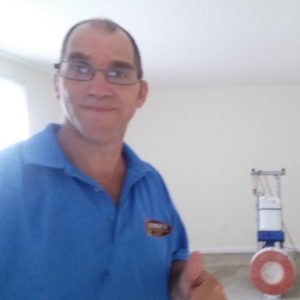 An employee of Hebert's Reliable Cleaning Solutions with carpet cleaning equipment in Chicopee, MA.