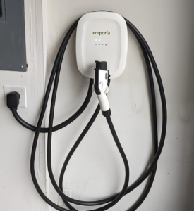 An Emporia electric vehicle charger professionally installed on a garage wall by Alt Electric LLC in Federal Way, WA.