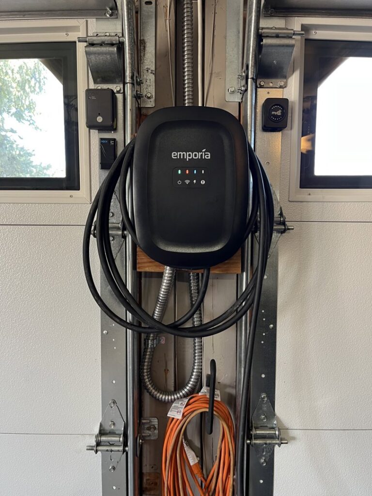 An Emporia EV charger professionally installed in a garage by ChargerPro in Denver, CO.