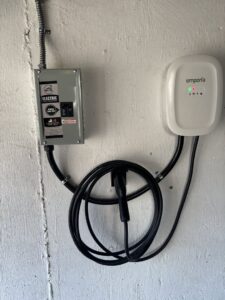An Emporia electric vehicle charging station professionally installed on a wall by J. Bathe Electric in Saint Charles, MO.