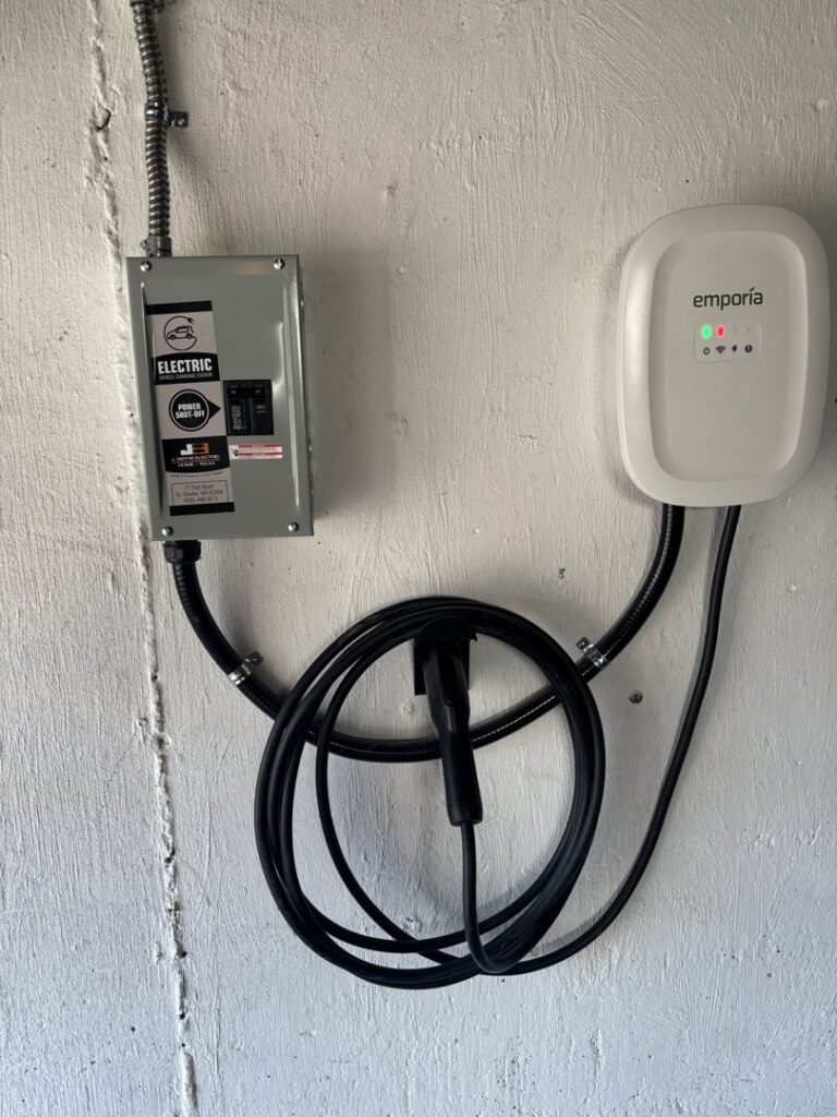 An Emporia electric vehicle charging station professionally installed on a wall by J. Bathe Electric in Saint Charles, MO.