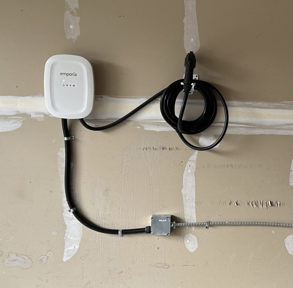 An Emporia EV charger professionally installed on a wall by ChargerPro in Denver, CO.