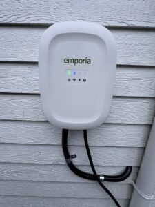 An installed Emporia EV charging station on residential siding by Watts Up Electric in Crystal Lake, IL.