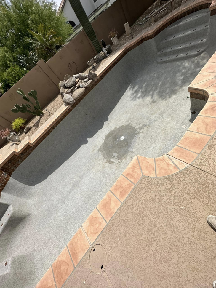 An empty, drained pool ready for cleaning, repair, or resurfacing by Prime Pool Care in Satellite Beach, FL.