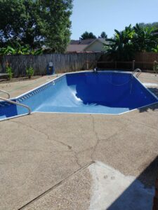An empty, newly lined pool with a unique curved shape, showcasing liner installation by Brian's Pool Service in Baton Rouge, LA.