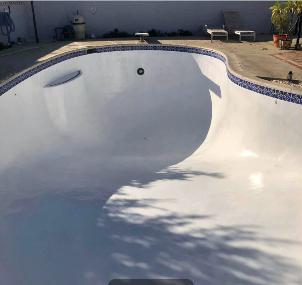 An empty swimming pool after draining, ready for cleaning or repair by Good Guy Pool Service in Moreno Valley, CA.