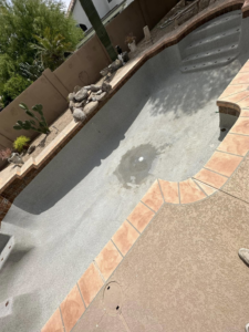 An empty pool showing the surface before a cleaning, repair, or resurfacing project by Prime Pool Care in Scottsdale, AZ