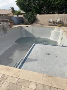 An empty swimming pool being refilled with water, indicating service by Pool Pals in Franklin, MA.
