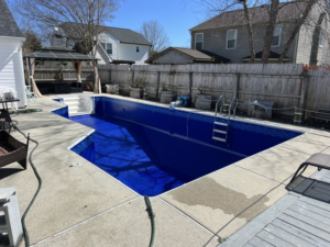 Empty pool with hoses and equipment for service by Pipeline Pools Inc. in Virginia Beach, VA.