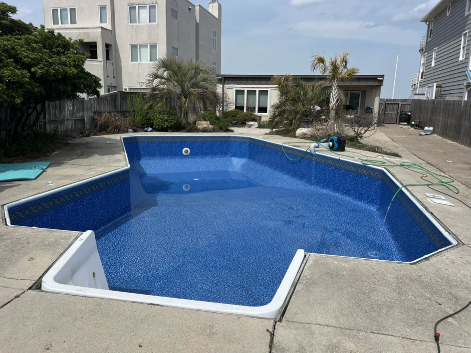 An empty inground pool with a newly installed blue liner by Pipeline Pools Inc. in Virginia Beach, VA.