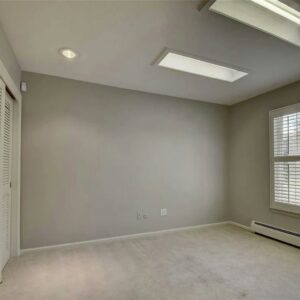 A clean, empty room featuring a fresh light-colored carpet installation by Floors By Tomorrow in Aurora, CO