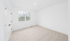 A newly carpeted empty room, showcasing professional carpet installation by Duke Brothers Oriental Rug Cleaning in Norfolk, VA.