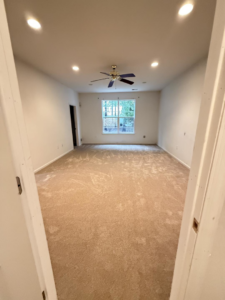 An empty room showcasing newly installed light-colored carpet by Vicoles Carpet & Flooring in Bayville, NJ.