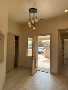 Elegant entryway chandelier and recessed lighting installation by O'Dell Electrical Services in Albuquerque, NM.