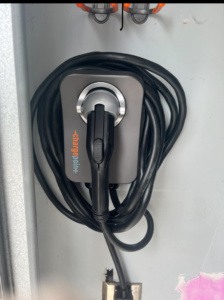 A ChargePoint EV charger neatly installed on a wall with its cable coiled by Rossetti Electric in Bethlehem, PA