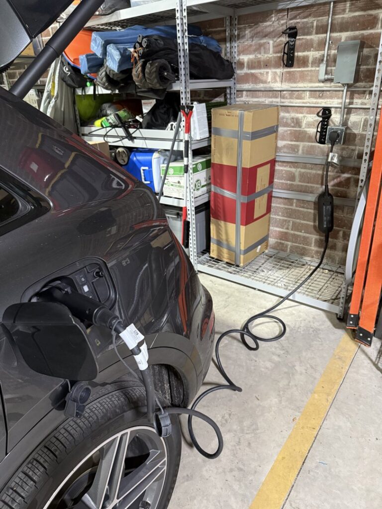 An electric vehicle (EV) charger installed and in use in a garage by Flavin Electric, LLC in Chicago, IL