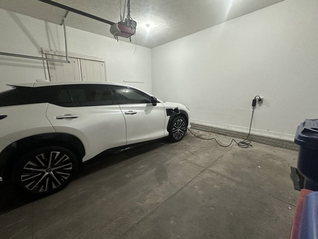 A newly installed electric vehicle charger on a garage wall by Black Power Redevelopers in Papillion, NE.