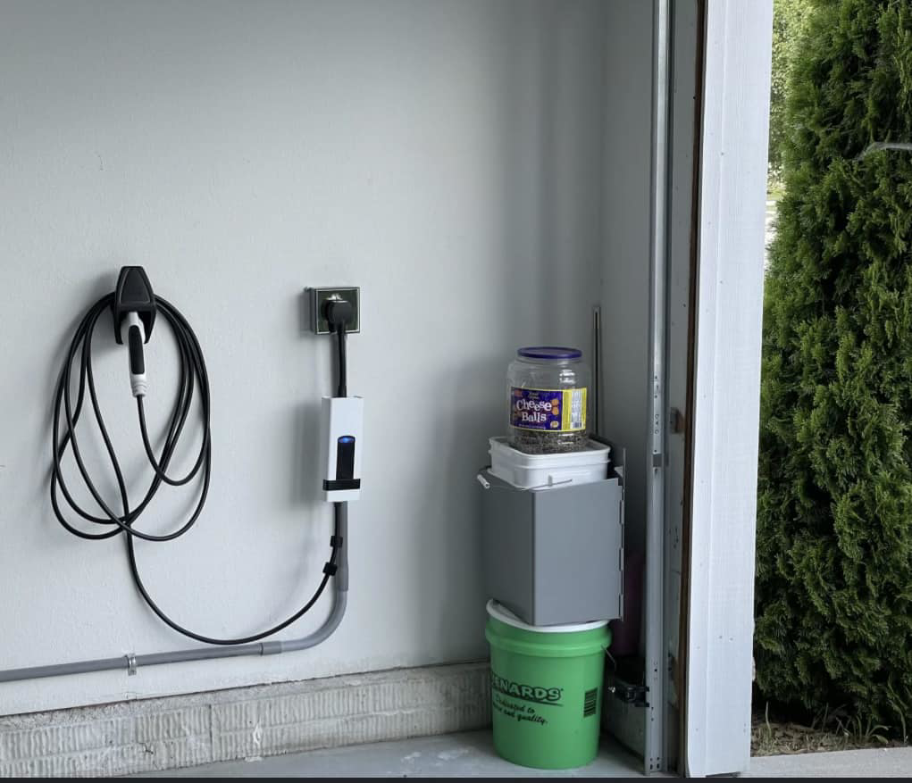 An electric vehicle charger professionally installed on a garage wall by EVC Pro Solutions in Marietta, GA.