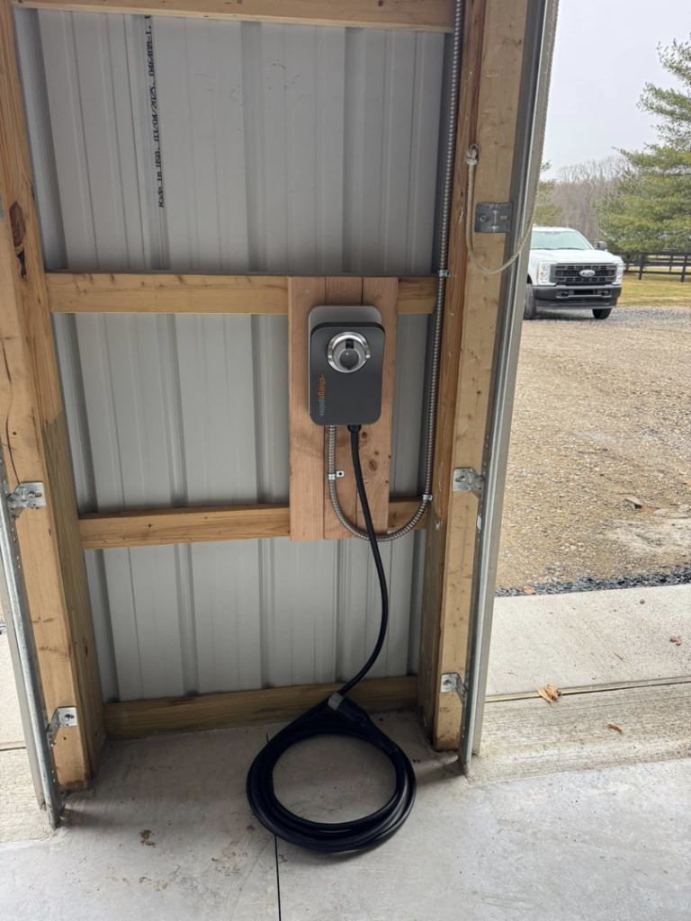 An EV charging station professionally installed in a garage by J Pownall Electric LLC in Hamilton, NJ.