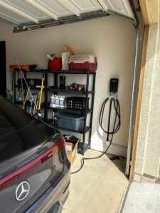 An electric vehicle charging station installed in a residential garage by Pro Solutions Electric in Glendale, AZ.