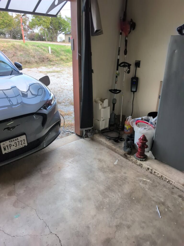 Electric vehicle charger installed in a garage by TJAM Electric in Springtown, TX.