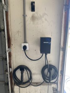 An EV charger (Grizzl-E) installation on a garage wall by CLB Electrical LLC in Townsend, DE.